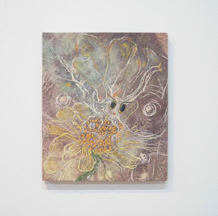 a painting-like object with textile stretched over a support. there is an image, loosely discernible, of an insect next to a yellow flower. there are also pink nipples visible beside the insect