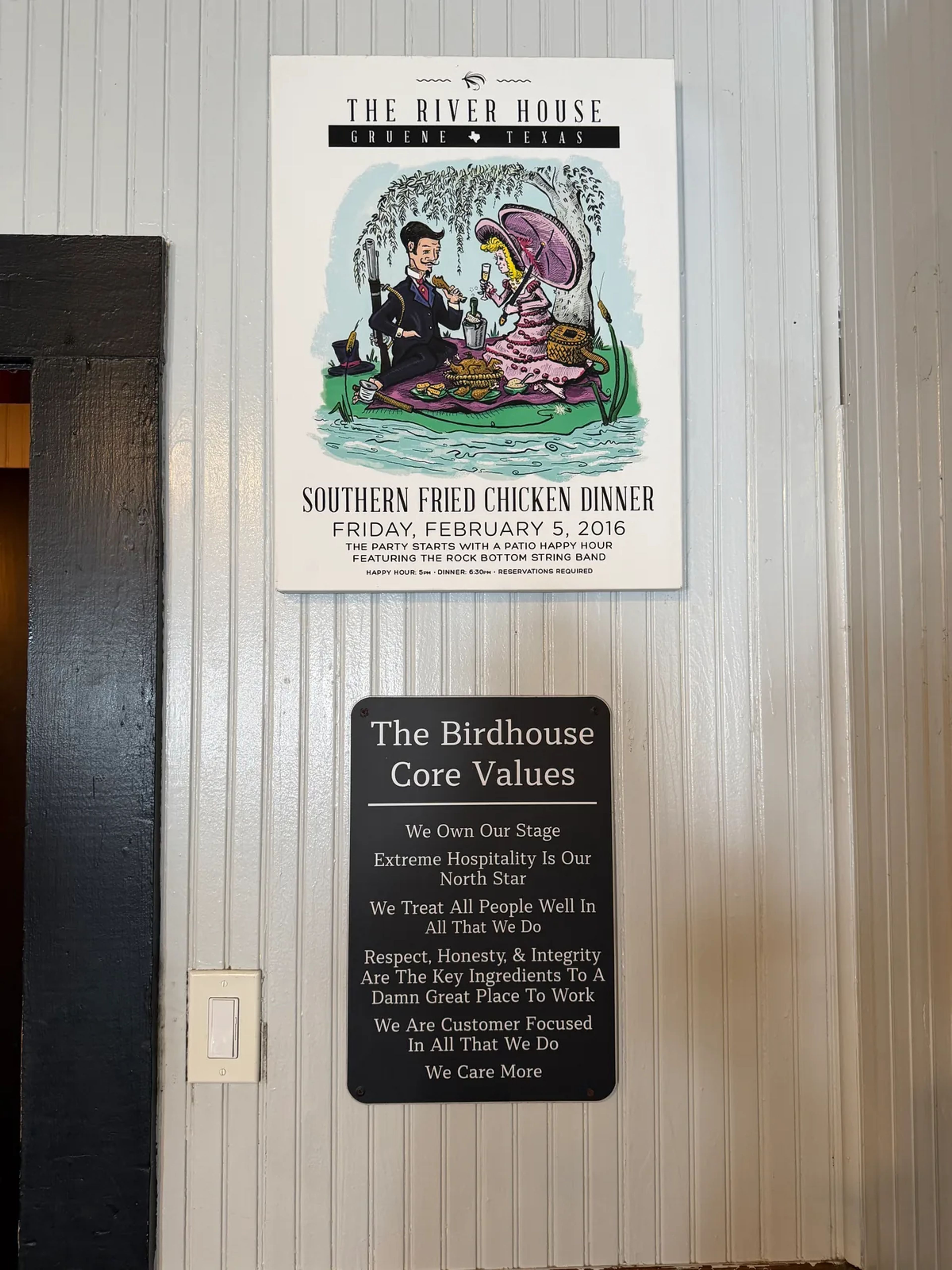 A River House poster for a Southern Fried Chicken Dinner on Friday, February 5, 2016, showing a couple picnicking with fried chicken, above The Birdhouse Core Values sign