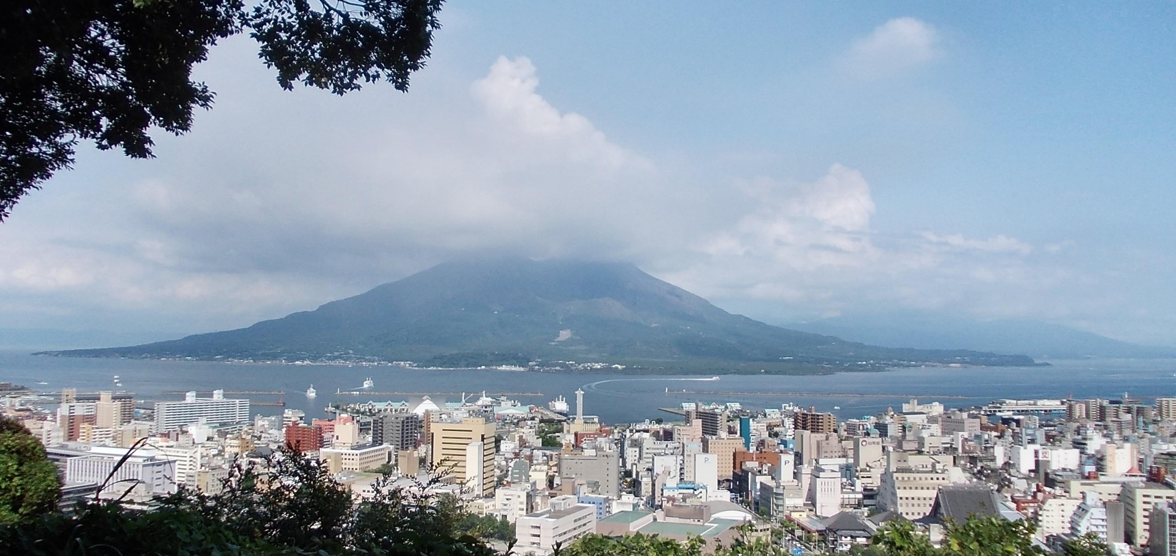 Sakurajima volcano rising across Kinko Bay above the Kagoshima cityscape