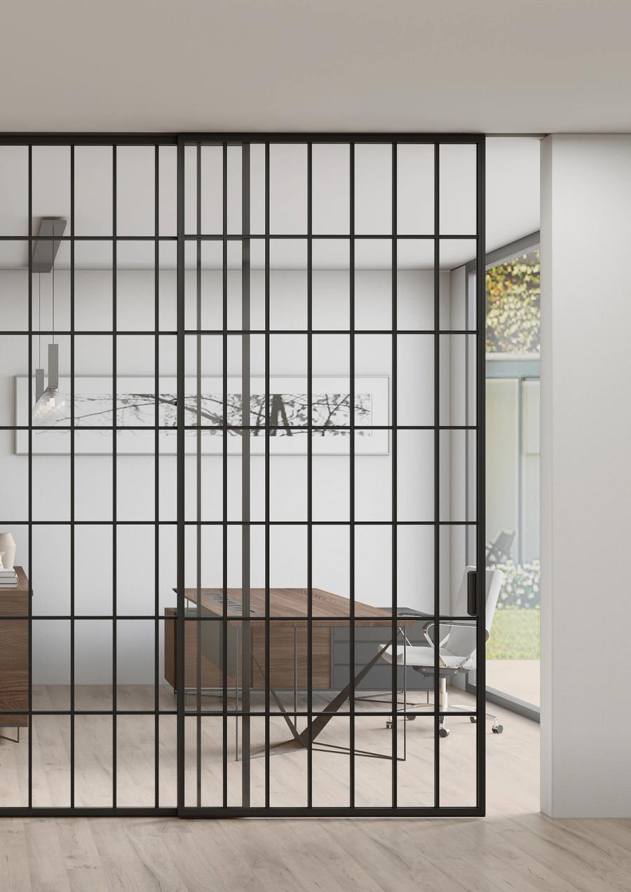 SHOGUN partition panel in a hospitality setting, dual-tone aluminium frame with fabric-laminated glass infill showing a woven texture, pendant light visible thr