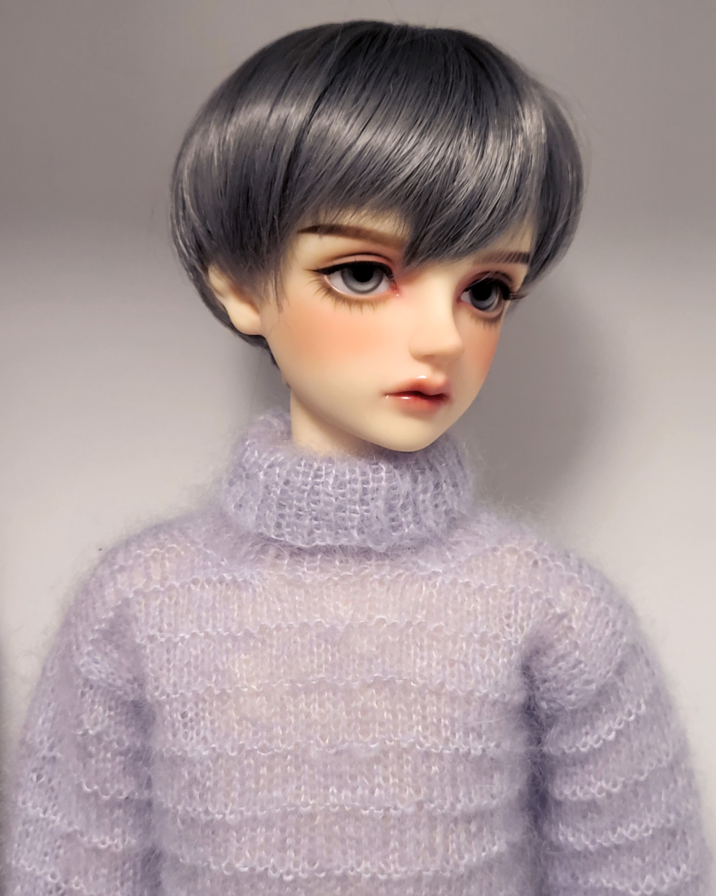 Male resin ball-jointed doll with short grey hair, grey eyes, a boyish face and a fluffy mohair jumper.