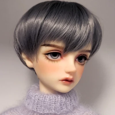 Male resin ball-jointed doll with short grey hair, grey eyes, a boyish face and a fluffy mohair jumper.