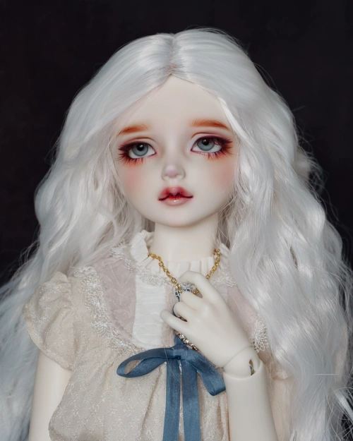 Female ball-jointed doll with long wavy white hair, blue eyes, wearing a cream lacy blouse, with her hand covering the pendant of a necklace.
