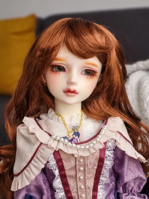 Red-haired female resin ball-jointed doll wearing an elaborate purple dress with cream drapery.