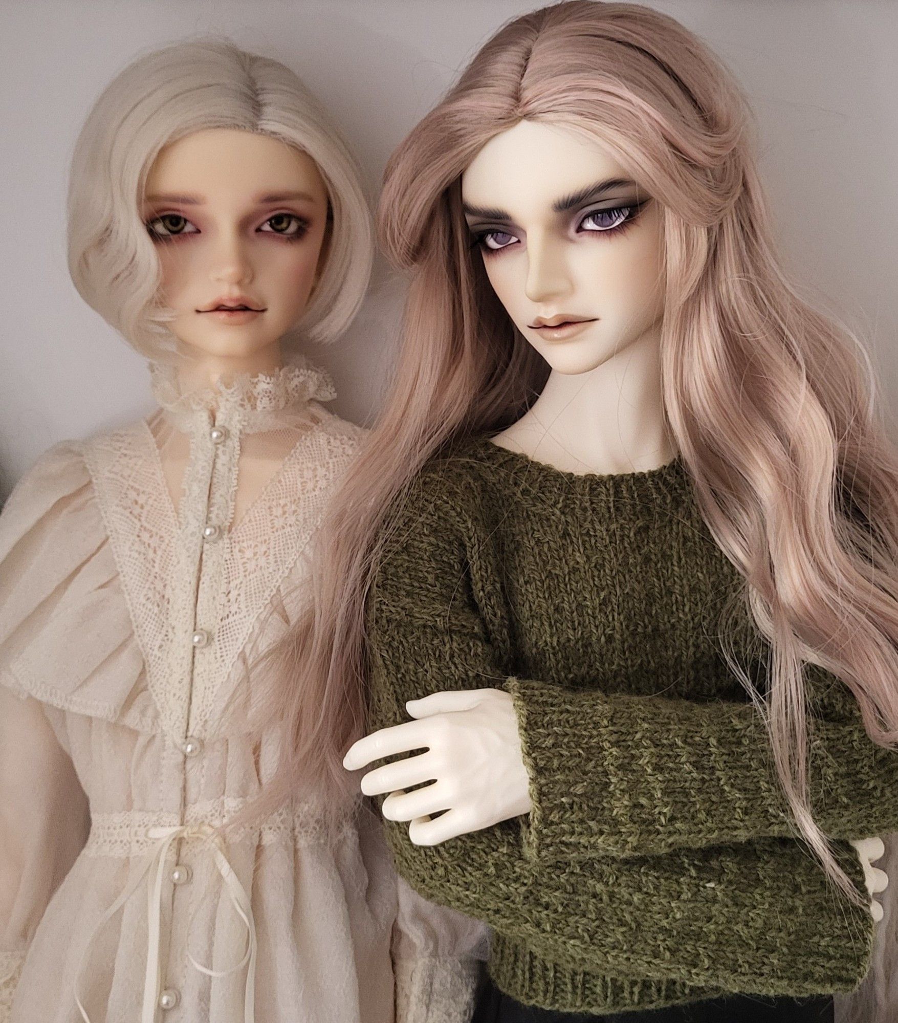 Male ball-jointed doll with thick eyebrows, heavy eyeshadow, and long pink hair.