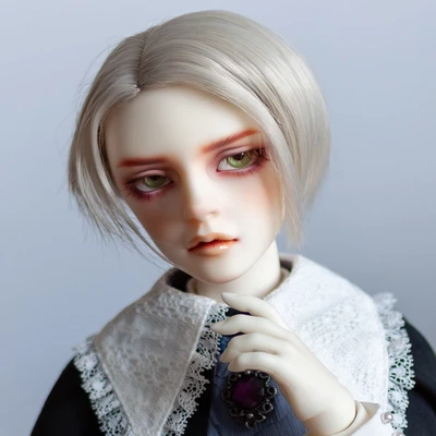 Male resin ball-jointed doll with short silver hair, pale green eyes and a sulky face, wearing a cloak with a lace collar.