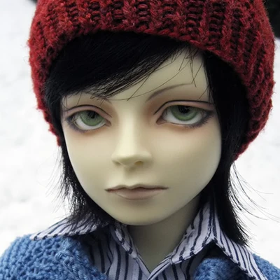 Male resin ball-jointed doll with short black hair and green eyes, wearing a knitted blue cardigan and red beret.