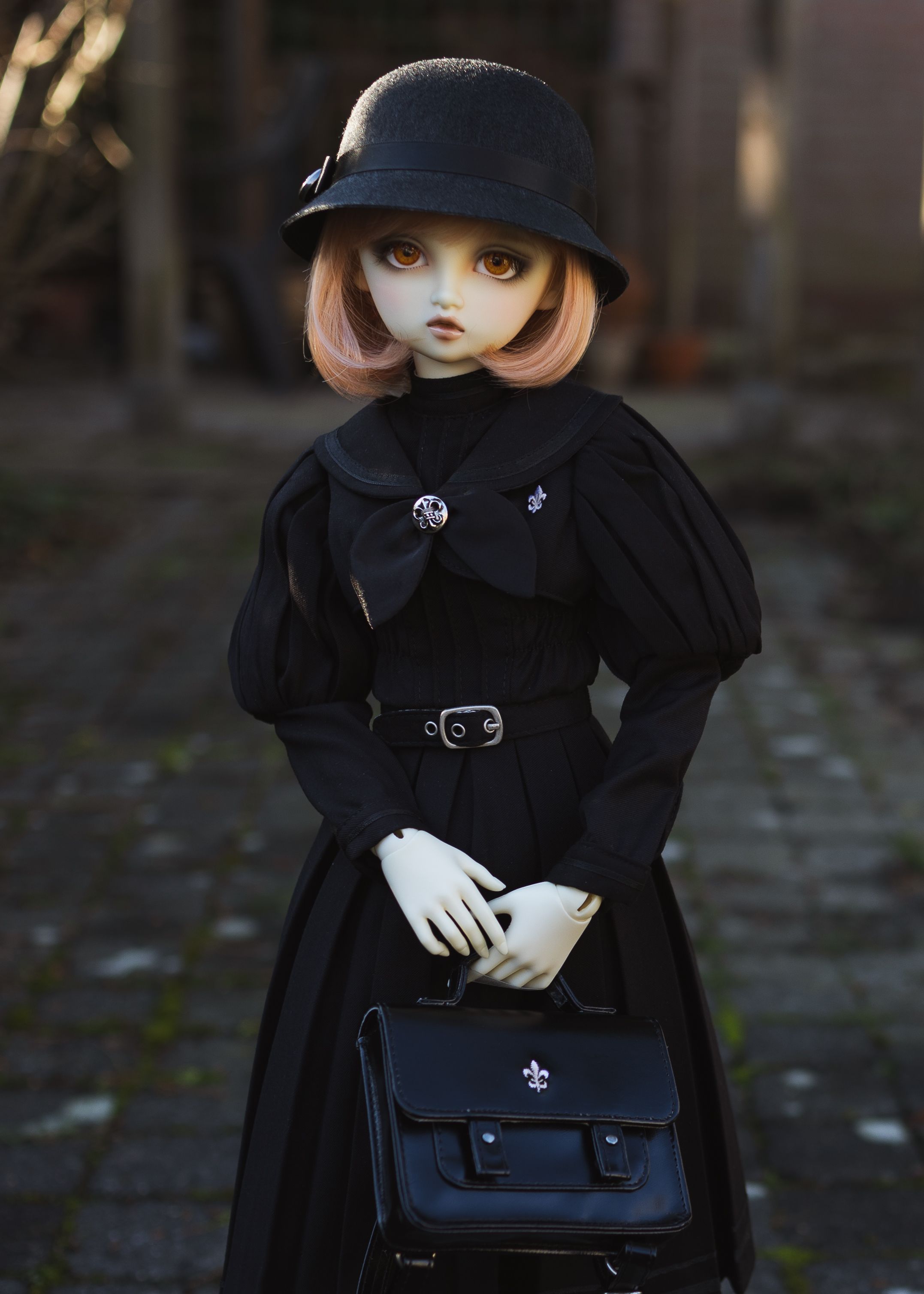 Female ball-jointed resin doll with bobbed pink hair, orange eyes, and a very sweet face.