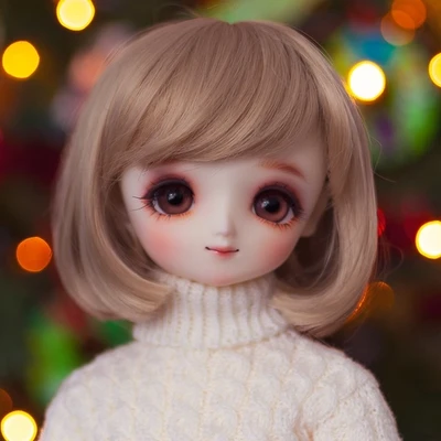Female ball-jointed resin doll with shoulder-length light brown hair, big wide brown eyes, and a cream knitted sweater.
