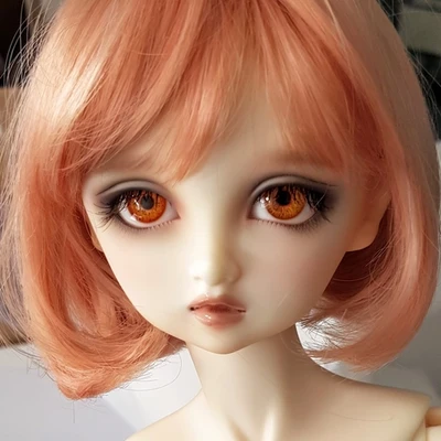 Female ball-jointed resin doll with bobbed pink hair, orange eyes, and a very sweet face.