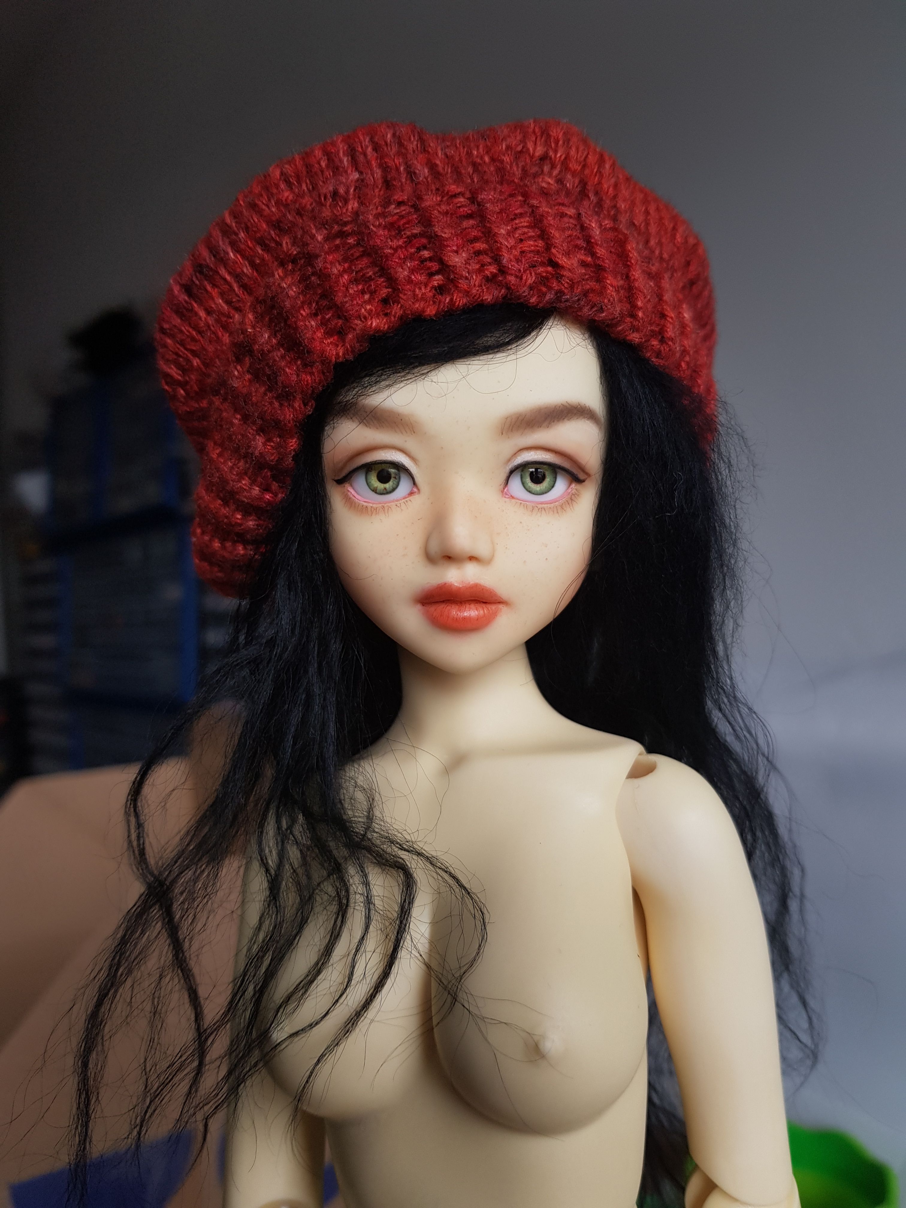 Female resin ball-jointed doll with long black hair and a sweet but stern face, wearing a red beret.