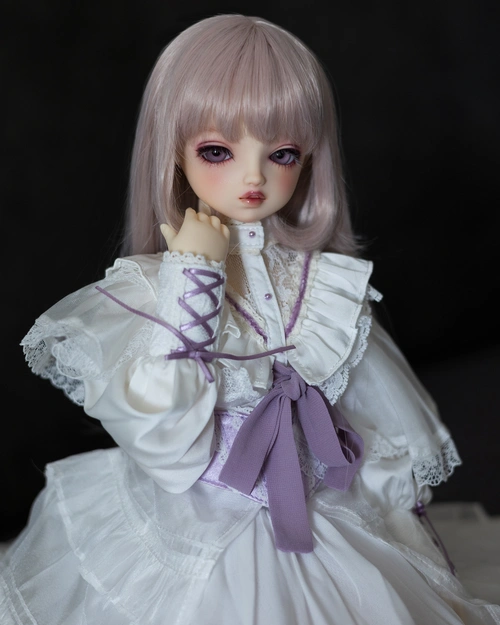 Female ball-jointed doll with a superior expresion, a light desaturated pink wig, and a frilled white dress with purple ribbon accents.