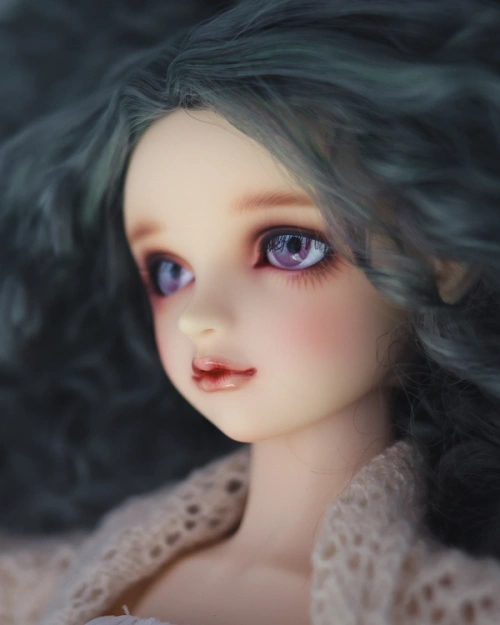 Close-up side view of a female ball-jointed resin doll's face.