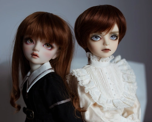 Photo of two resin ball-jointed dolls, a girl (Hazel) and a slightly taller boy (Hewitt), facing slightly away from each other. They both have red-brown hair. The girl wears a black school uniform with a white collar, and the boy wears a very frilly white shirt with lace.