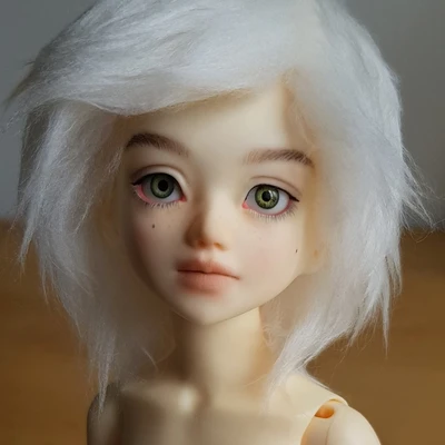 Ball-jointed resin doll with wispy white hair and a sweet, serious face.