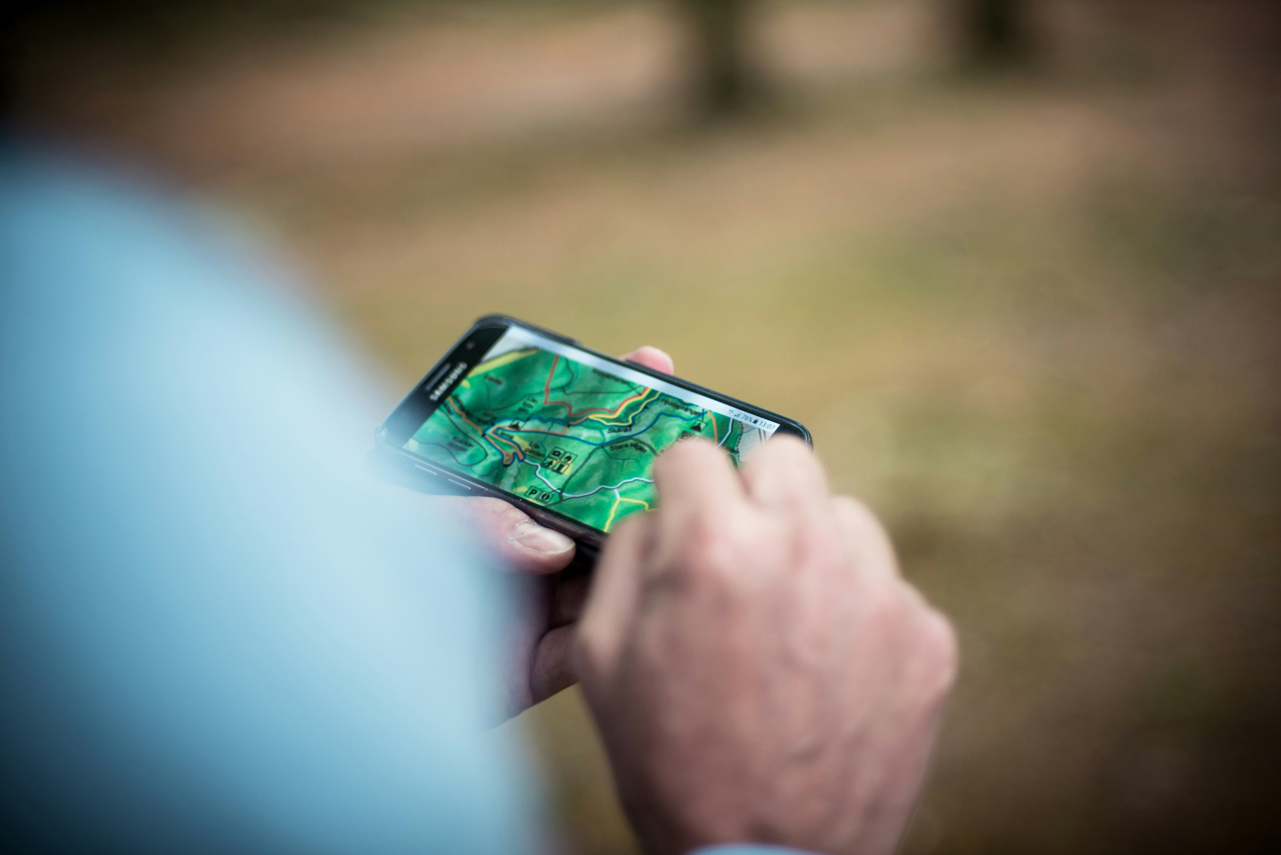 phone navigating hiking path