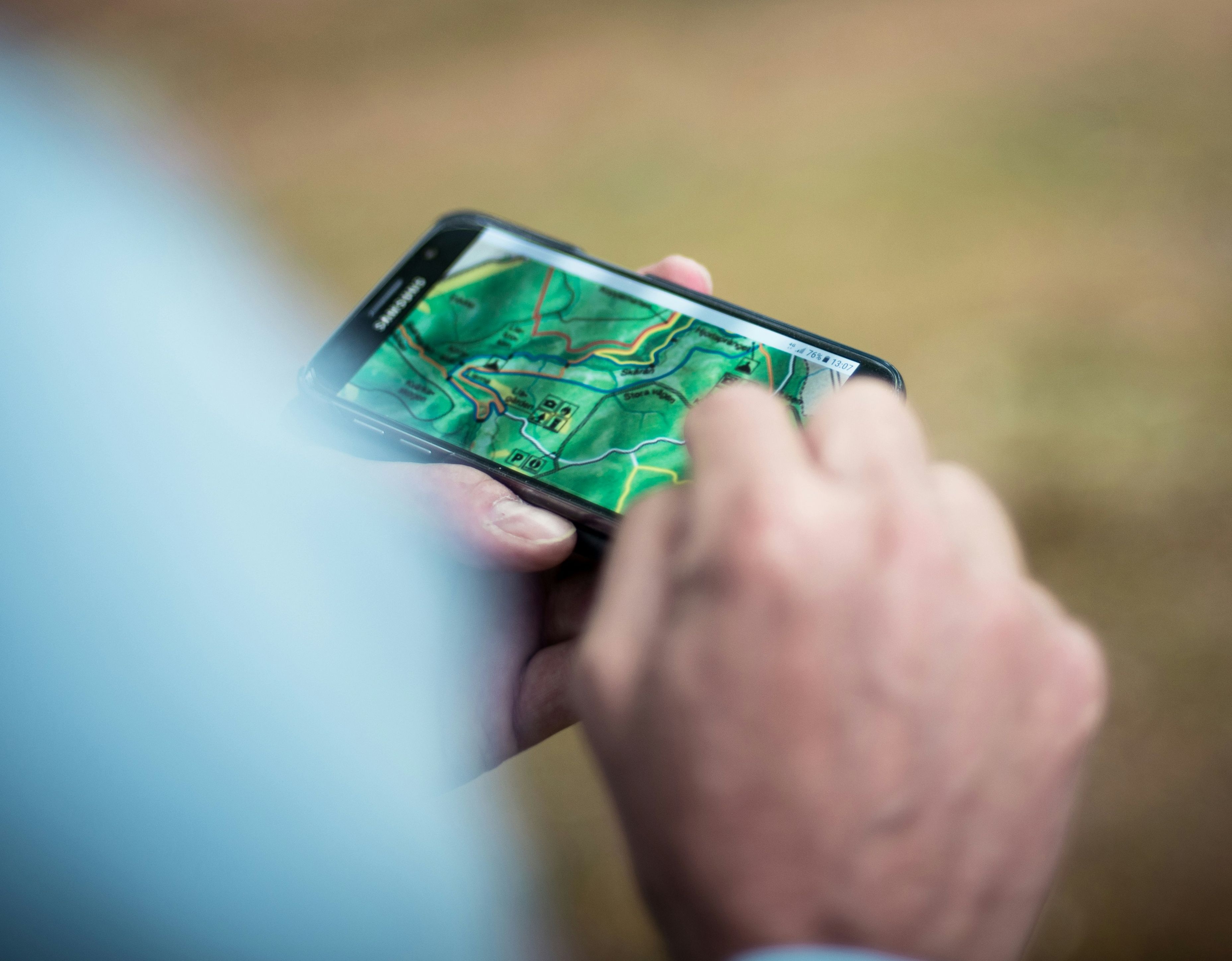 phone navigating hiking path