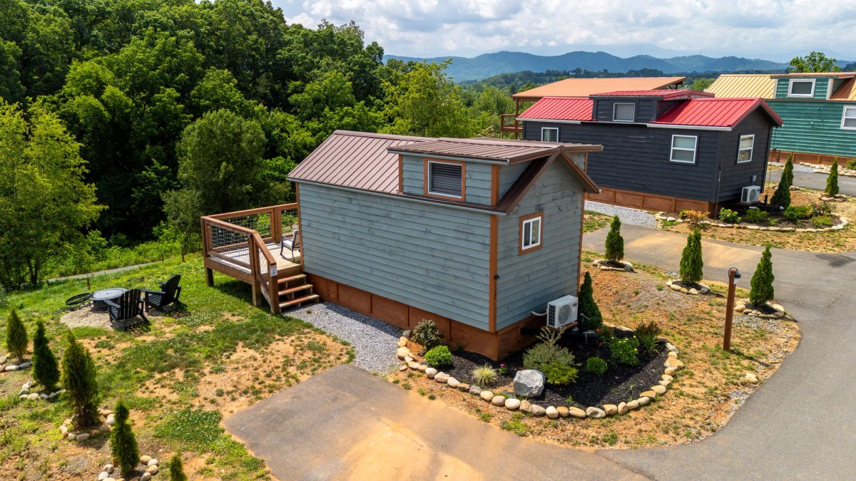 Aerial view of Sojourn Lodging colorful tiny home village with Smoky Mountains in the distance