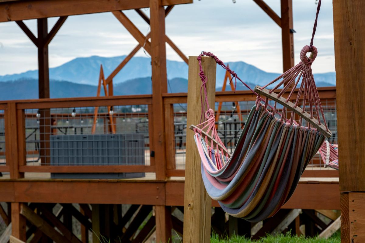 Hammock chairs on Sojourn Lodging observation deck with sweeping Smoky Mountains views