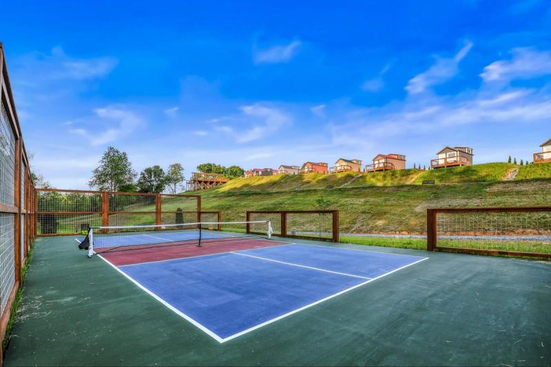 Pickleball court at Sojourn Lodging with tiny homes on the hillside