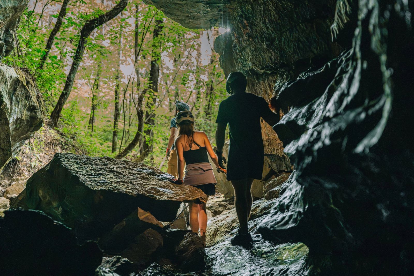 Guests climbing back toward the daylight at the mouth of the Sojourn Grotto cave