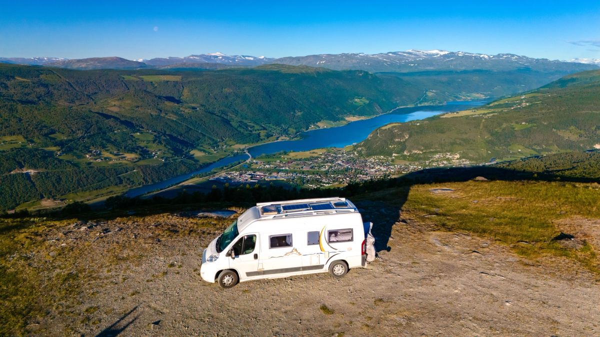 White van parked atop a mountain.