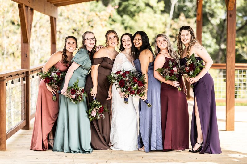 Bride and bridesmaids laughing together on the Observation Deck at Sojourn Lodging
