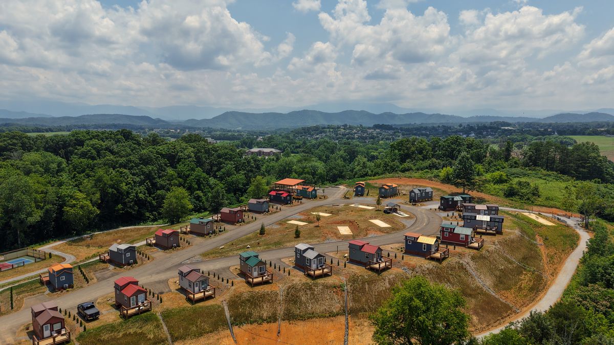 Aerial view of Sojourn Lodging tiny home village with Smoky Mountains in the background