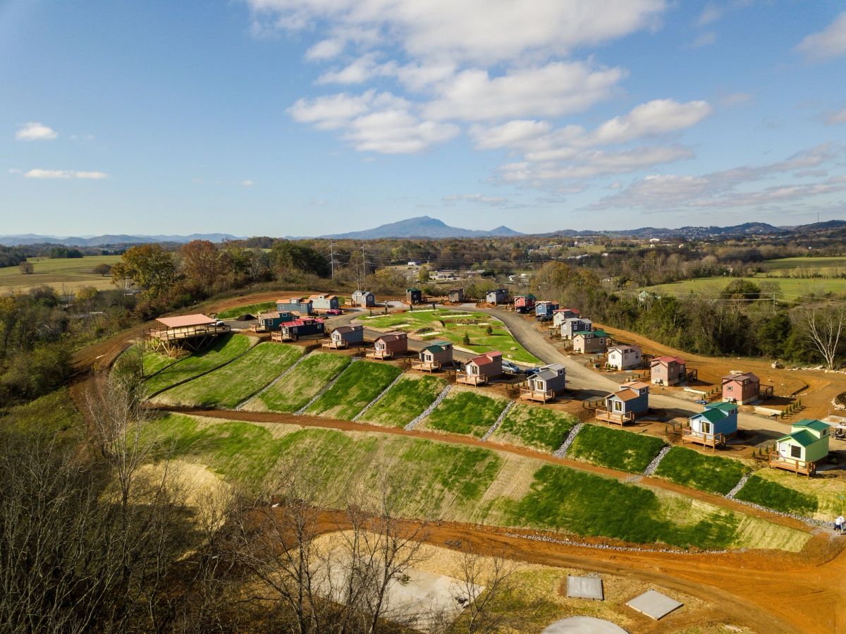 Aerial view of Sojourn Lodging tiny home village with Smoky Mountains in the background
