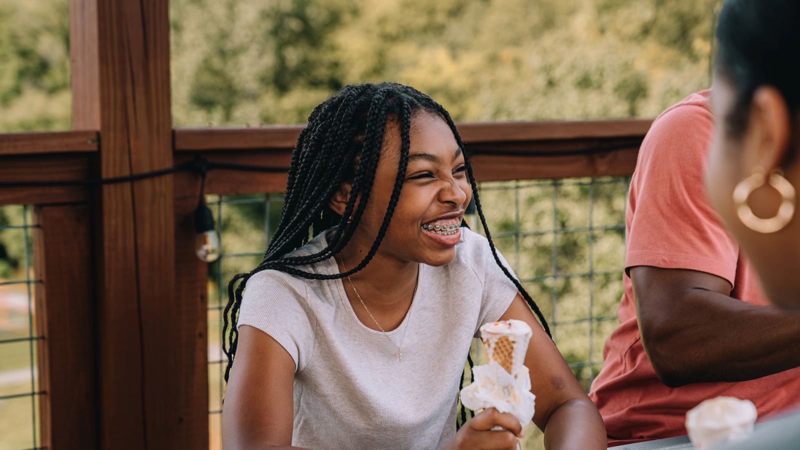 Two guests laughing over ice cream cones on the Observation Deck at Sojourn Lodging
