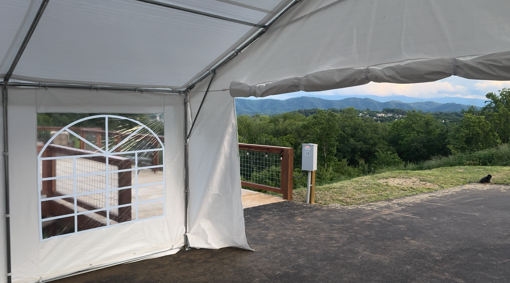 White event tent set up on the Observation Deck at Sojourn Lodging with Smoky Mountain views