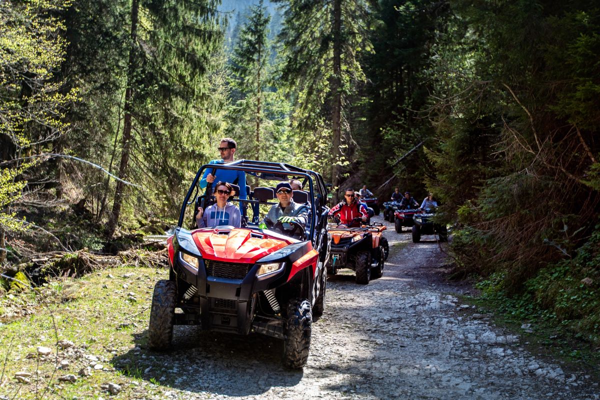 Guide conducting a UTV/ATV tour of a mountain.