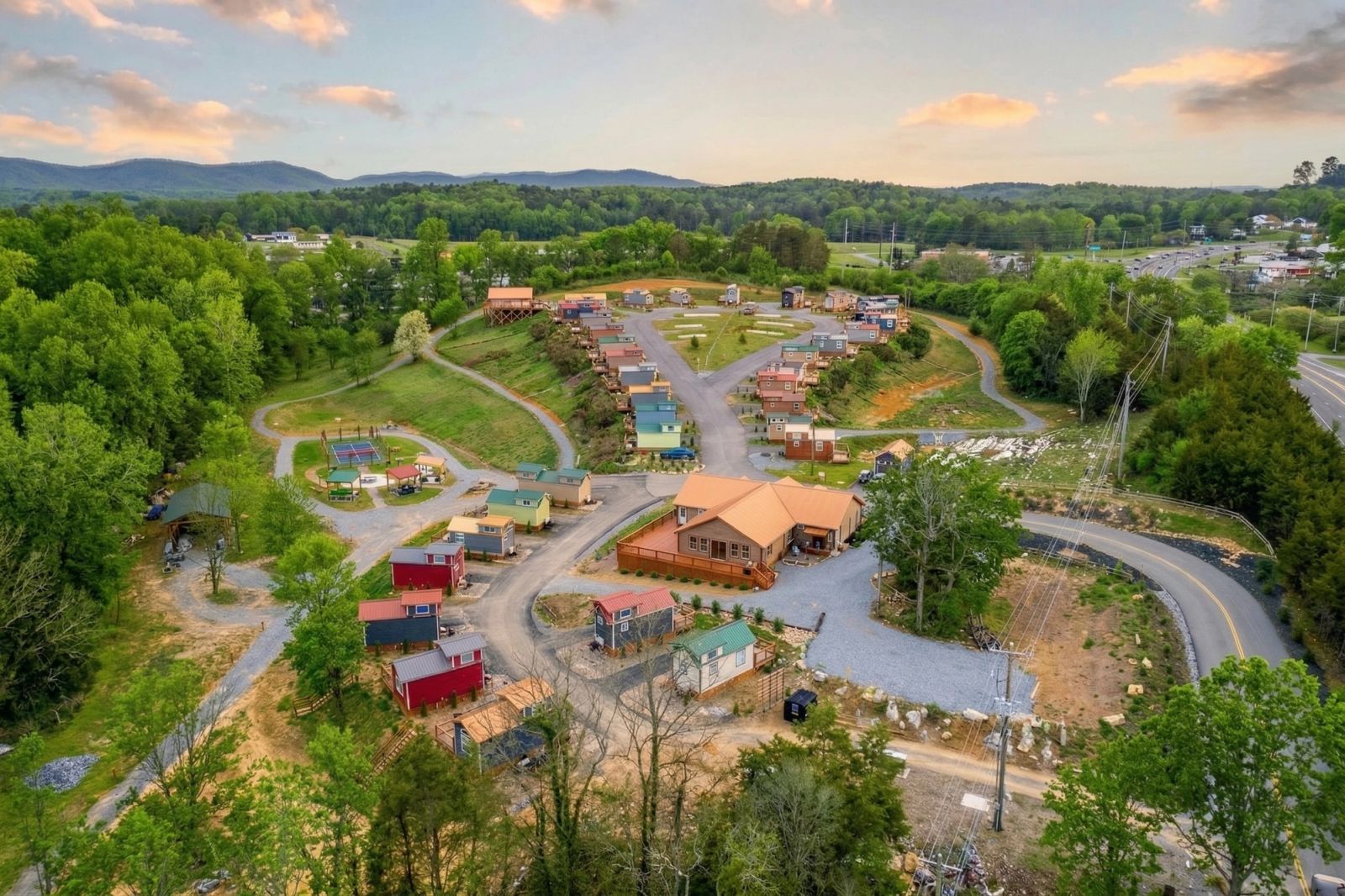 Aerial view over the tiny home village as the light fades at Sojourn Lodging