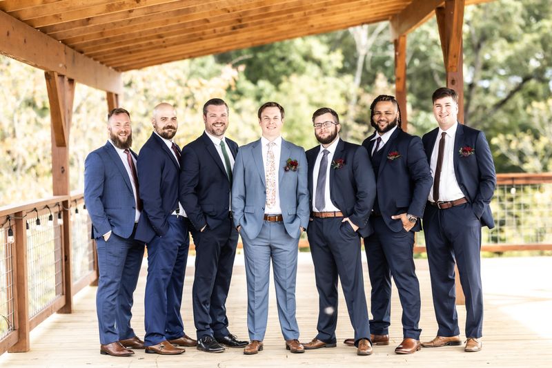 Groom and groomsmen posing on the Observation Deck at Sojourn Lodging