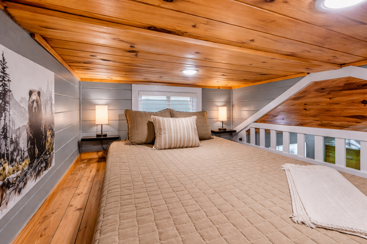 Cozy loft bedroom inside The Evergreen at Sojourn Lodging