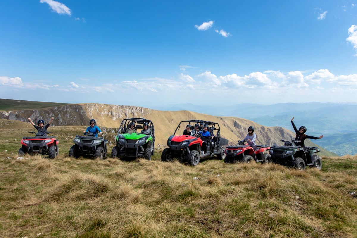 Group of ATVs lined up on a mountain.