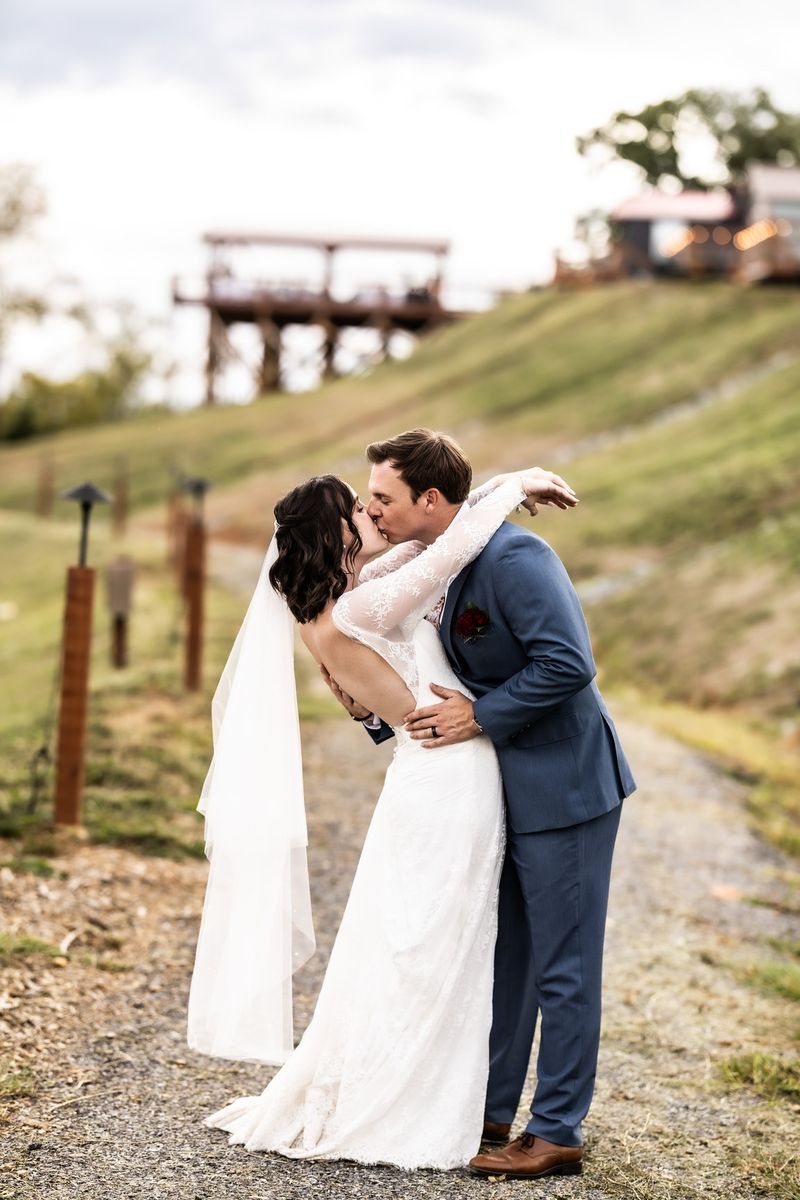 Bride and groom sharing a kiss on the path below the Observation Deck at Sojourn Lodging