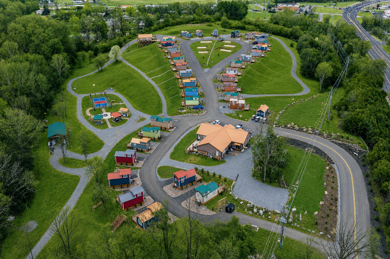 Aerial view of Sojourn Lodging tiny home village with colorful homes and shared spaces