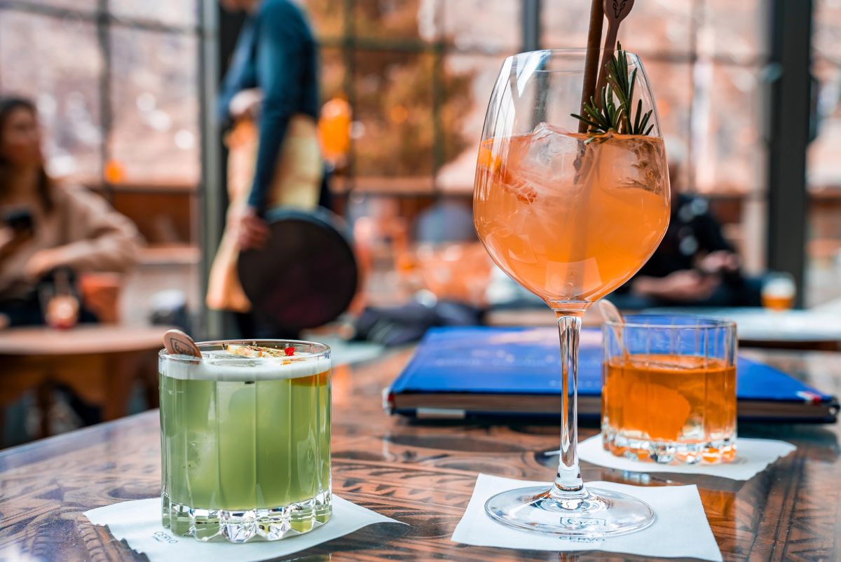 Two dining glass up on a bar.