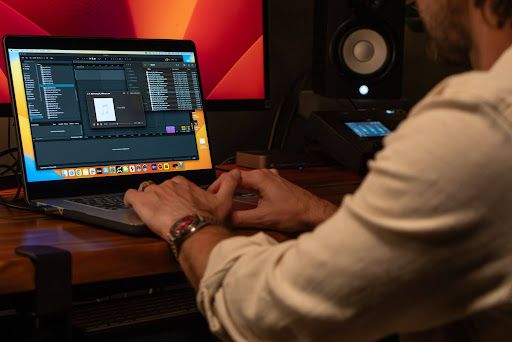 Artist working on digital audio production on his laptop