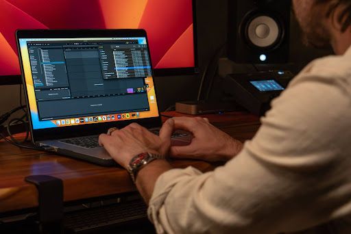 Person working on music production software in a recording studio.