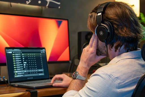 A musician making a beat on his laptop