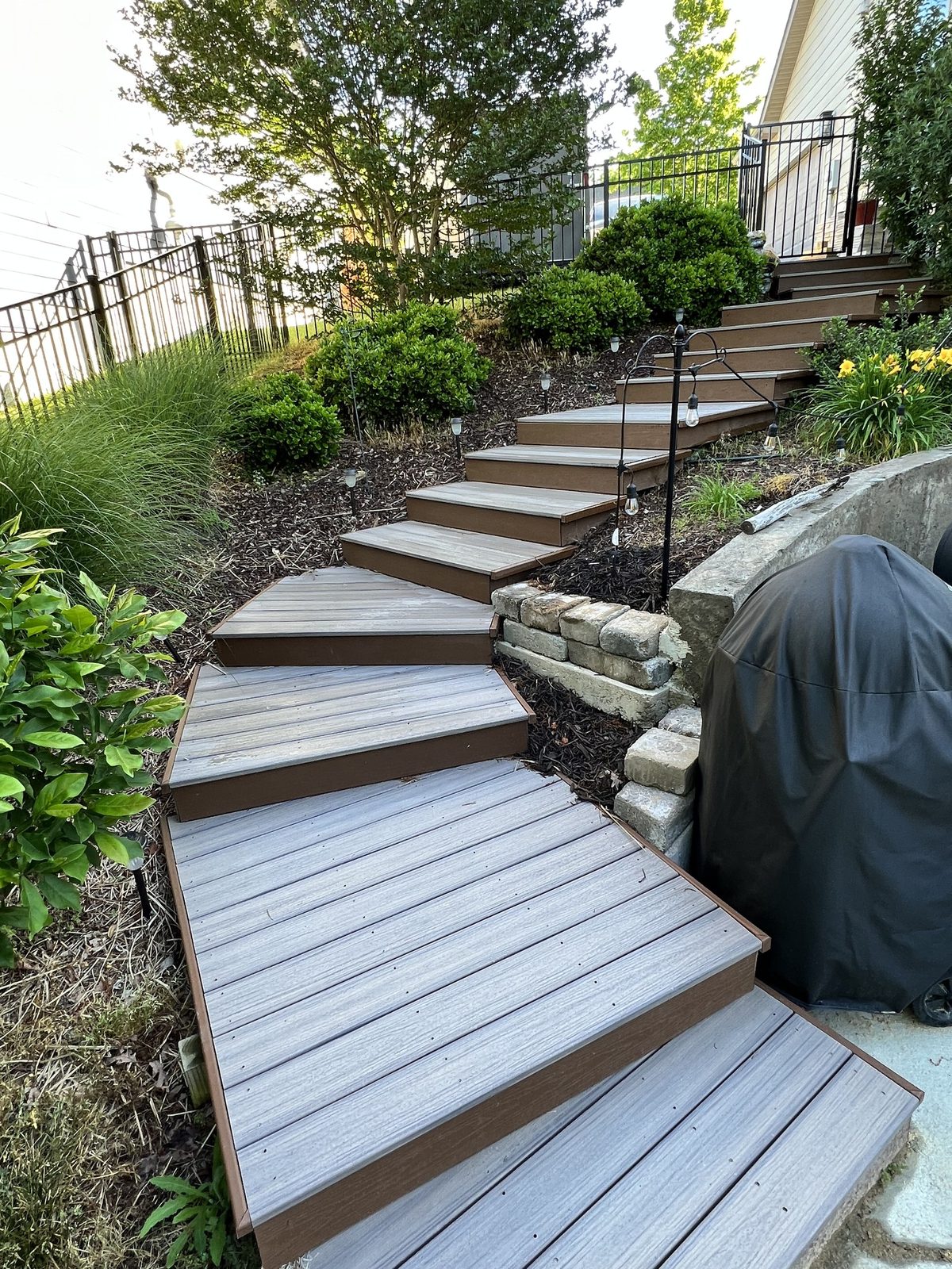 Landscaped composite stairway with garden beds and retaining wall