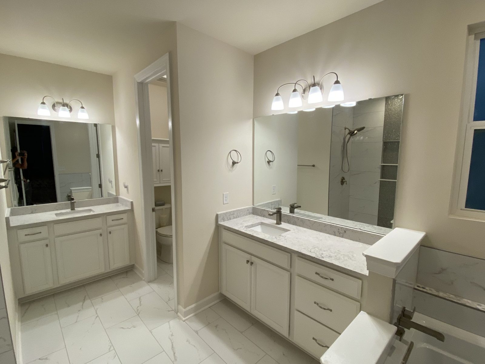 Bright bathroom with double vanity and walk-in glass shower