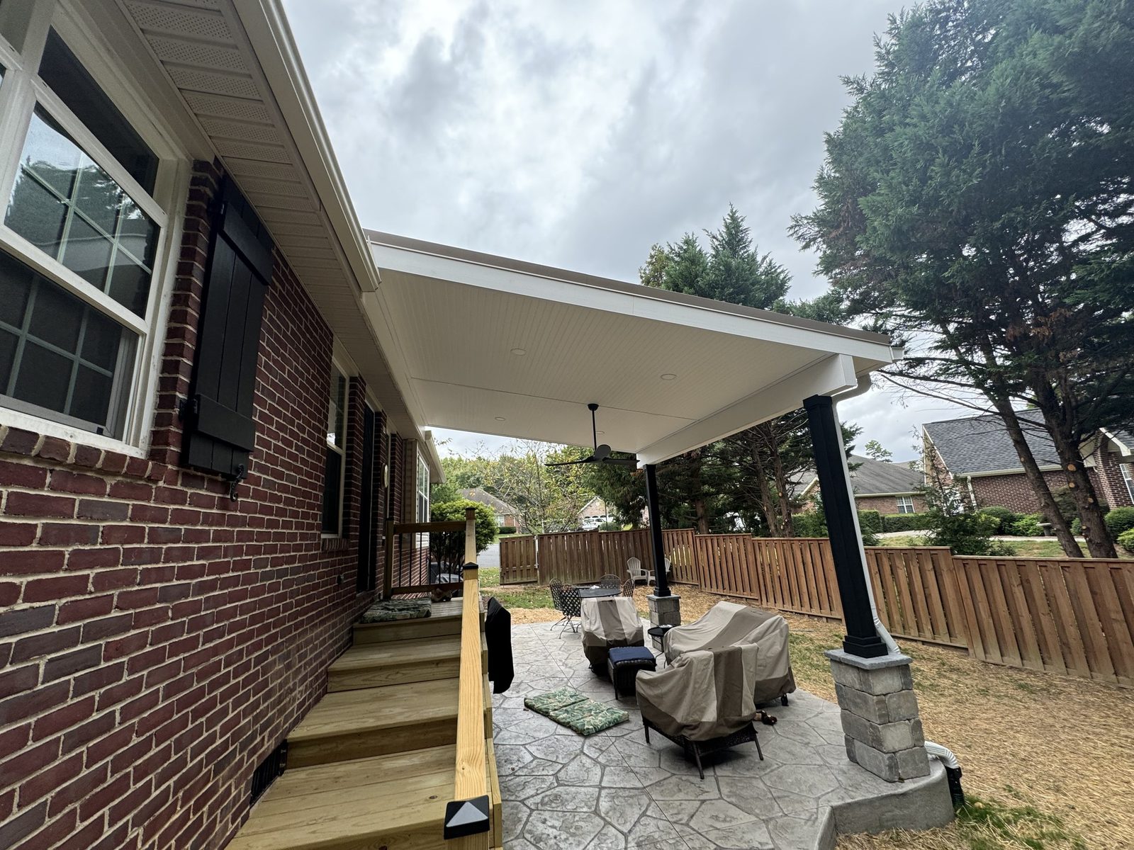 Covered patio on a brick home with outdoor furniture