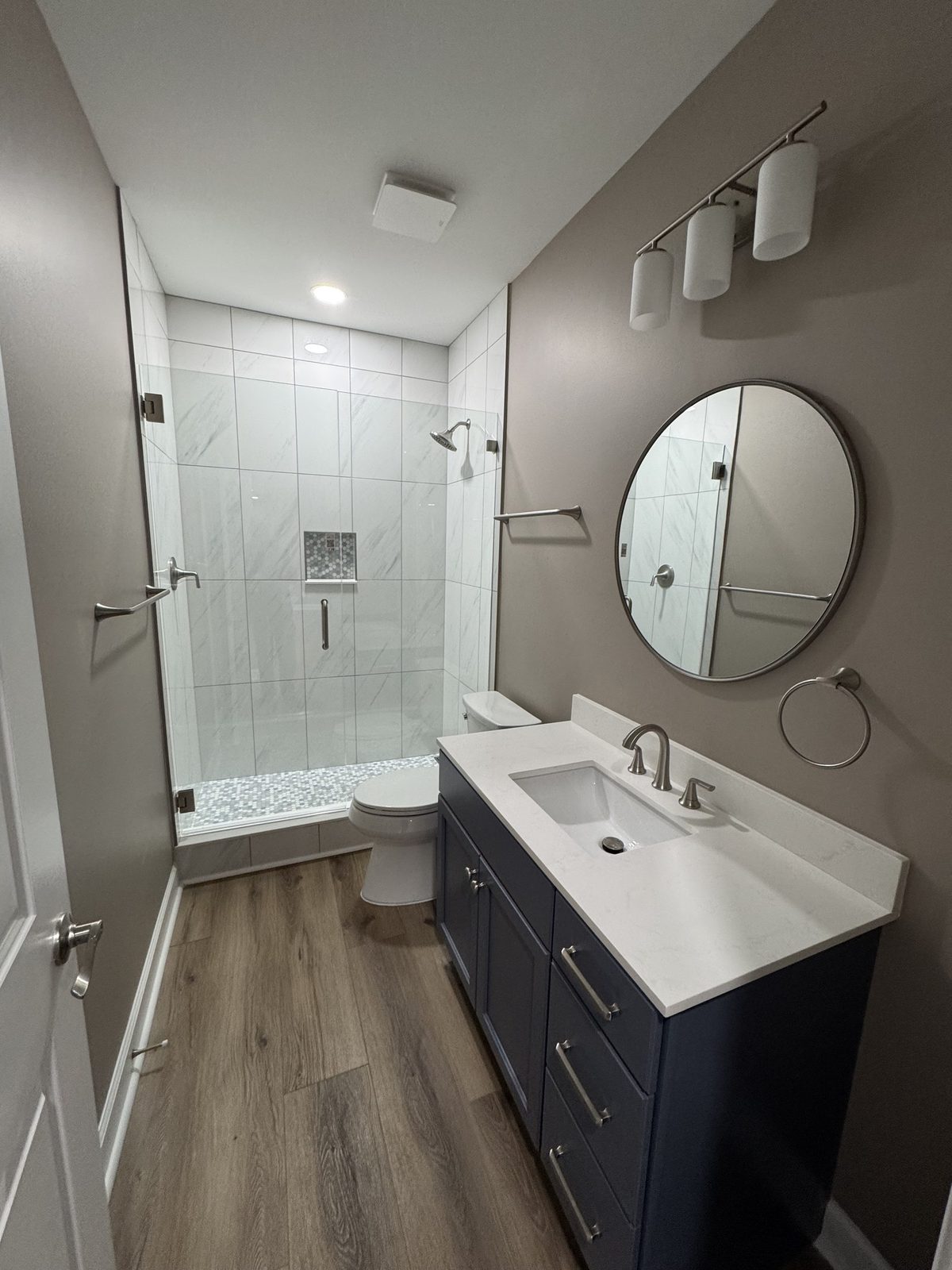 Modern bathroom with vanity and tiled walk-in shower