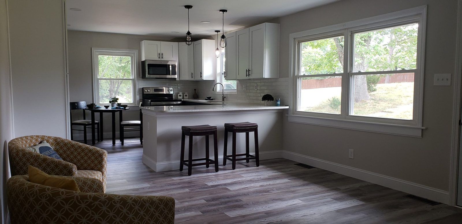 Open-concept kitchen with island seating and hardwood floors