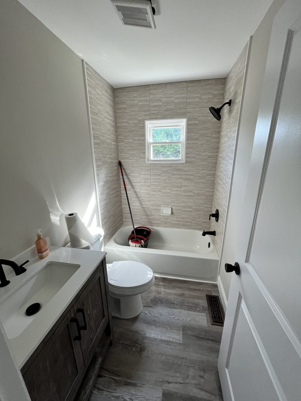 Full bathroom with vanity and subway tile tub-shower