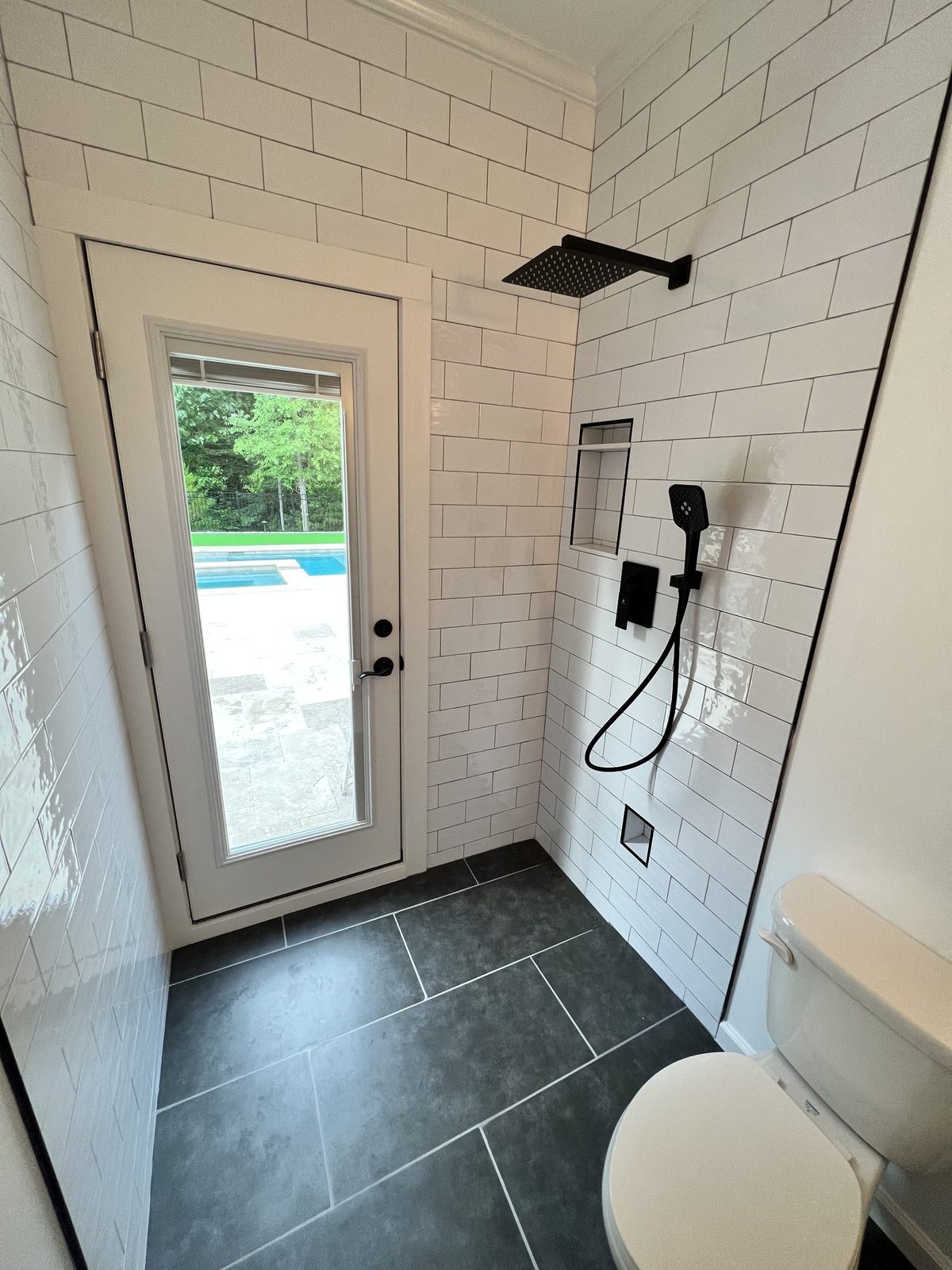 Subway tile walk-in shower with matte black fixtures
