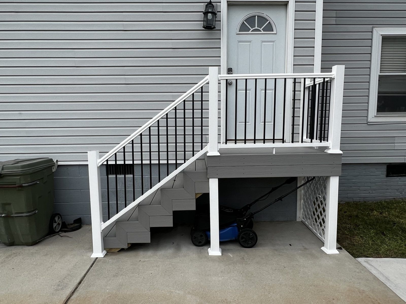 Elevated deck with white railings and staircase